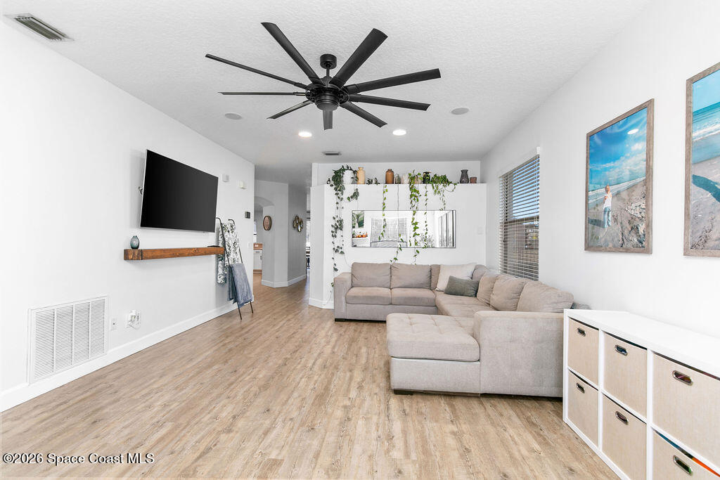 1209 Bolle Circle Rockledge, FL 32955 - Photo 12 of 28 a living room with furniture and a flat screen tv