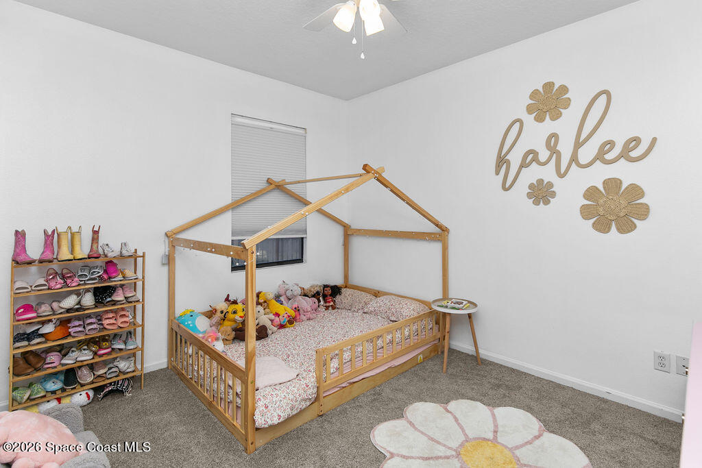 1209 Bolle Circle Rockledge, FL 32955 - Photo 20 of 28 a bed room with a bed and a chair