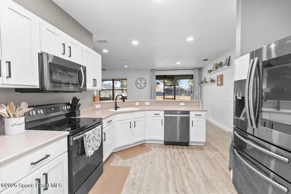 a kitchen with a sink stove and refrigerator