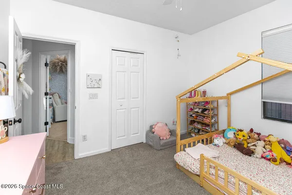 a bedroom with bed and closet