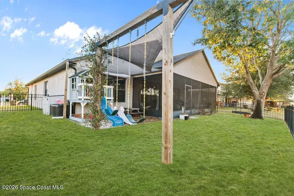 a view of a house with a yard patio and fire pit