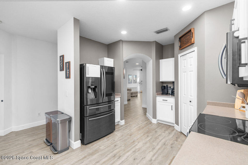 1209 Bolle Circle Rockledge, FL 32955 - Photo 5 of 28 a kitchen with stainless steel appliances a refrigerator stove and sink