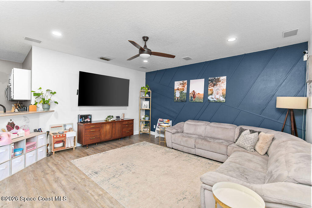 1209 Bolle Circle Rockledge, FL 32955 - Photo 8 of 28 a living room with furniture and a flat screen tv