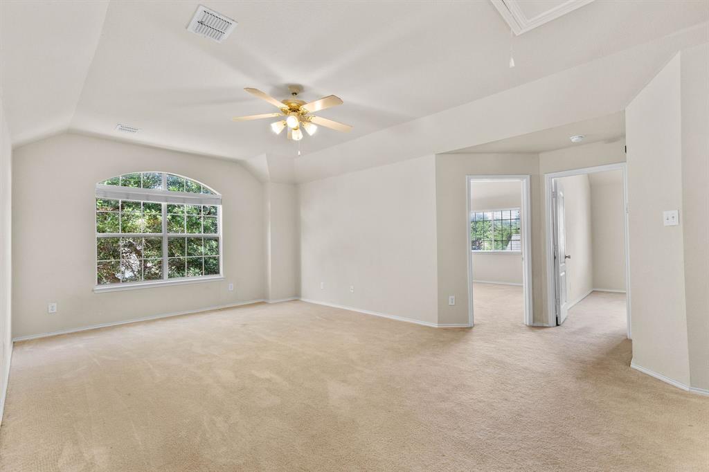 2700 Hereford Road Denton, TX 76210 - Photo 20 of 36 Spacious room with vaulted ceilings and neutral carpeting