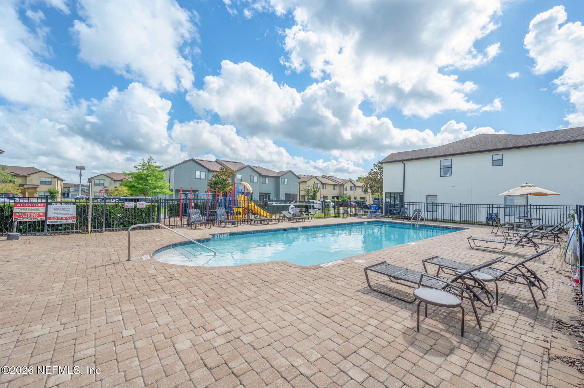 253 Syrah Way St. Augustine, FL 32084 - Photo 39 of 39 a view of a swimming pool with lounge chairs in front of house