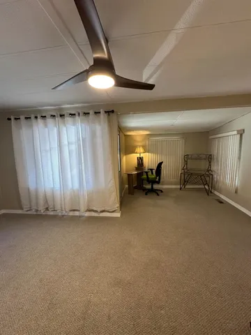 a view of empty room with furniture and a flat screen tv