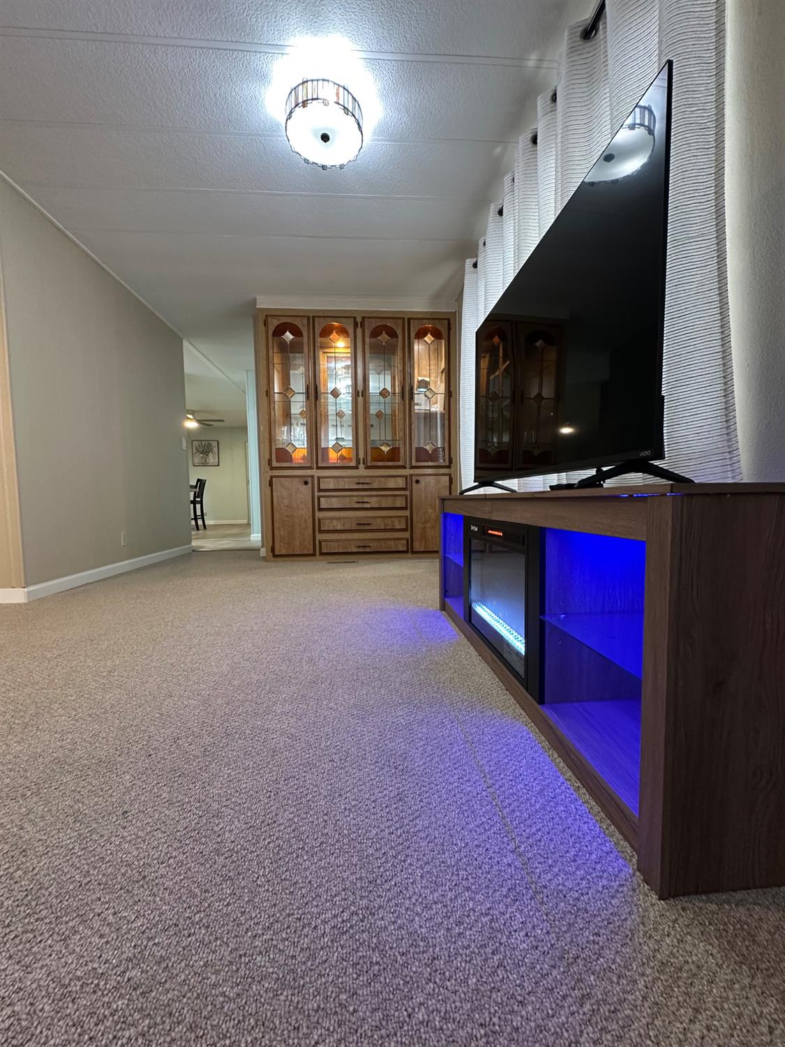 1200 South Carpenter Road, Unit 105 Modesto, CA 95351 - Photo 31 of 38 a view of empty room with furniture and a flat screen tv