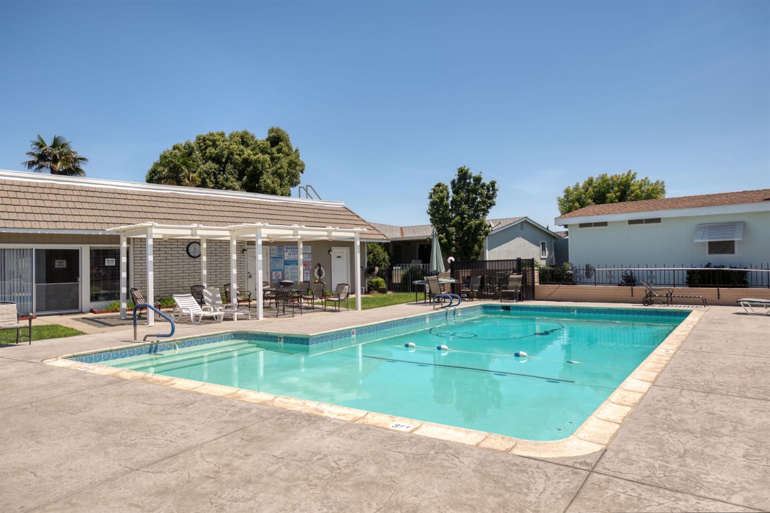 1200 South Carpenter Road, Unit 105 Modesto, CA 95351 - Photo 36 of 38 a view of a house with swimming pool and a yard