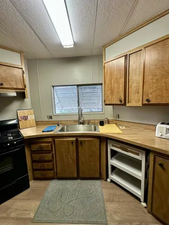 a kitchen with stainless steel appliances granite countertop a refrigerator stove and sink