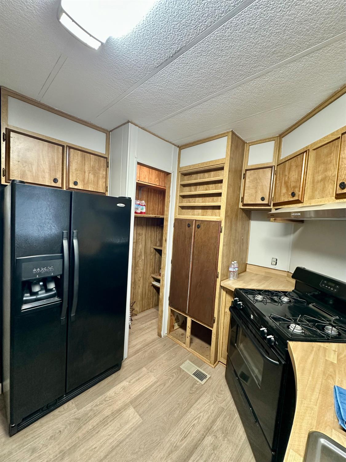 1200 South Carpenter Road, Unit 105 Modesto, CA 95351 - Photo 8 of 38 a kitchen with stainless steel appliances granite countertop a refrigerator stove and sink