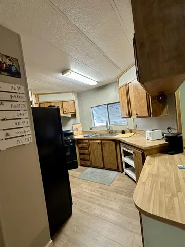 a kitchen with a stove and a refrigerator