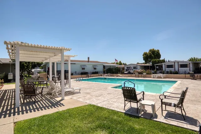 a swimming pool with outdoor seating and yard