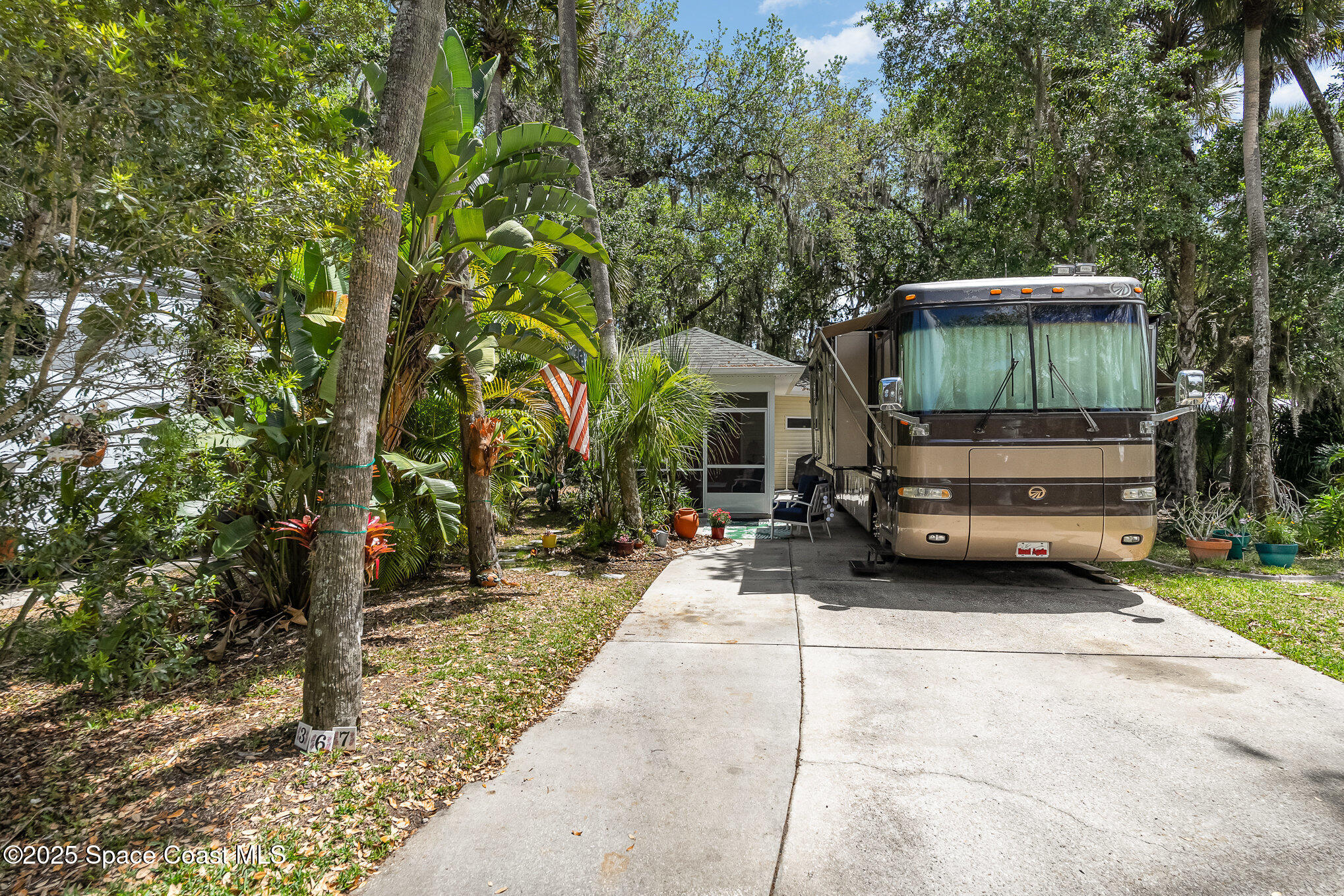367 Oak Cove Road Titusville, FL 32780 - Photo 1 of 15 a view of backyard with outdoor seating and trees
