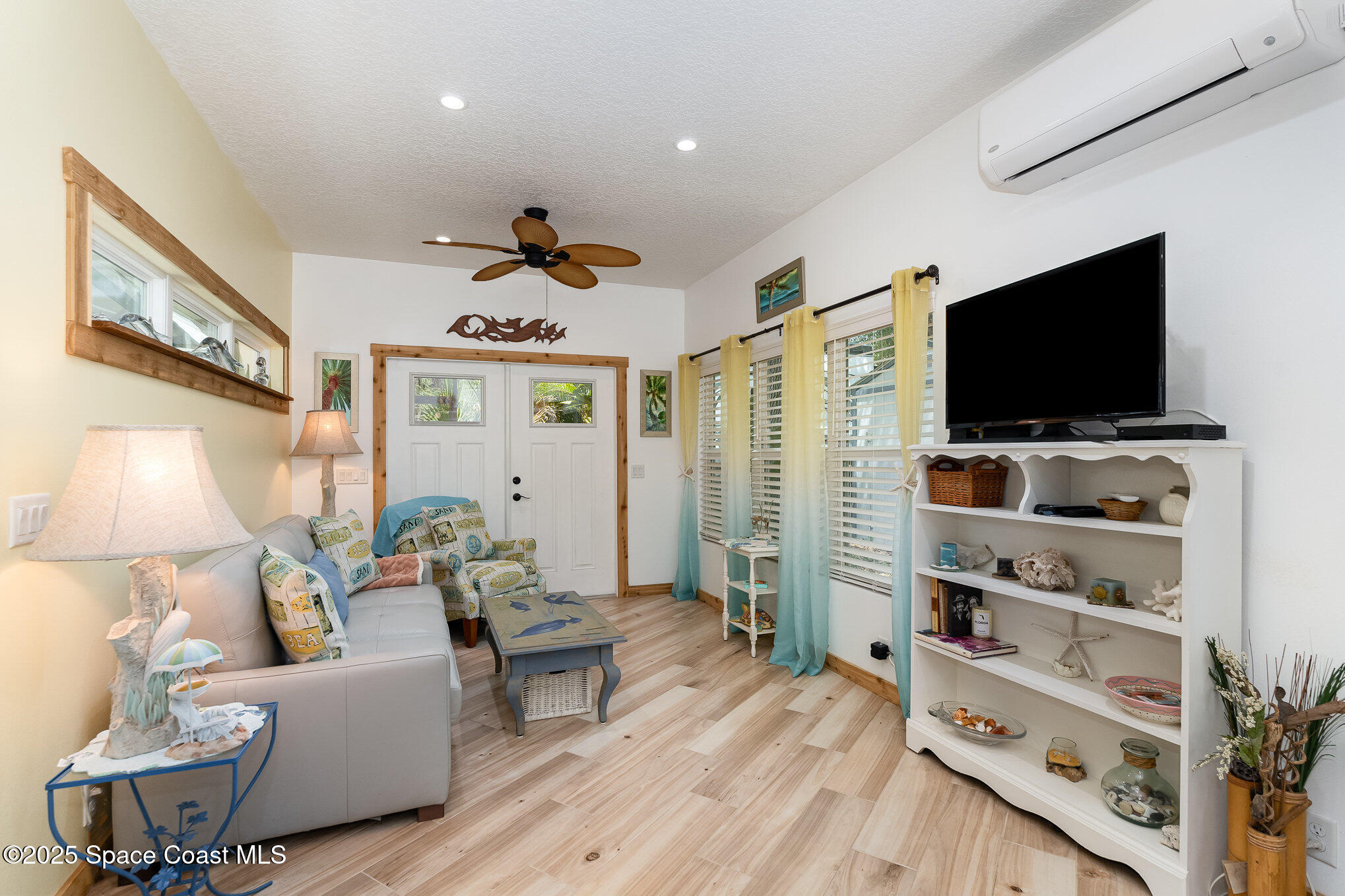 367 Oak Cove Road Titusville, FL 32780 - Photo 14 of 15 a living room with furniture and a flat screen tv