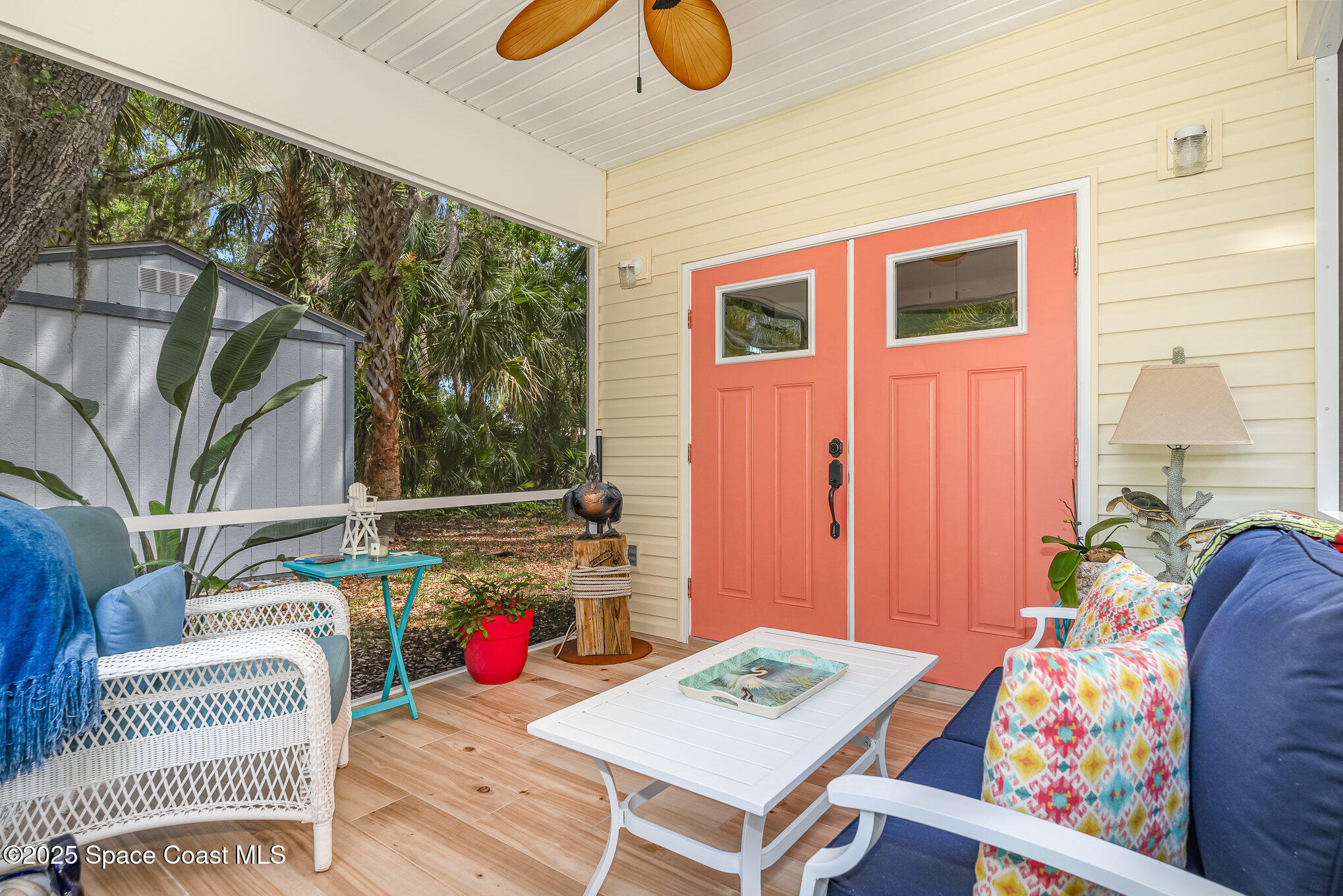 367 Oak Cove Road Titusville, FL 32780 - Photo 3 of 15 a living room with patio furniture and a potted plant