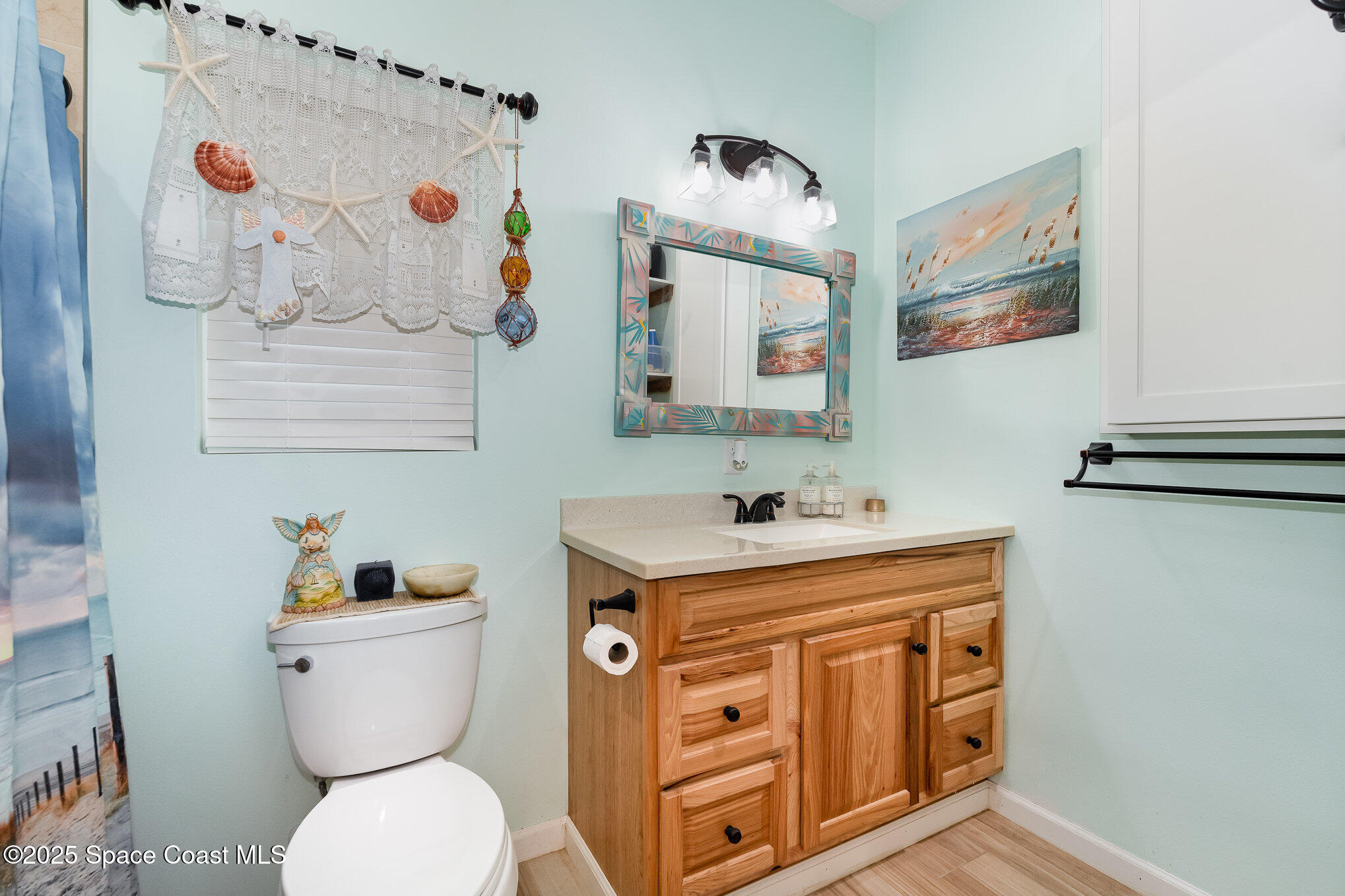 367 Oak Cove Road Titusville, FL 32780 - Photo 7 of 15 a bathroom with a toilet a sink and a mirror