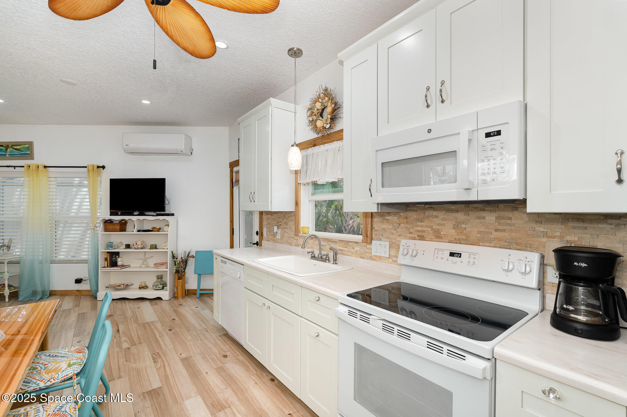 367 Oak Cove Road Titusville, FL 32780 - Photo 9 of 15 a kitchen that has a lot of white cabinets and stainless steel appliances