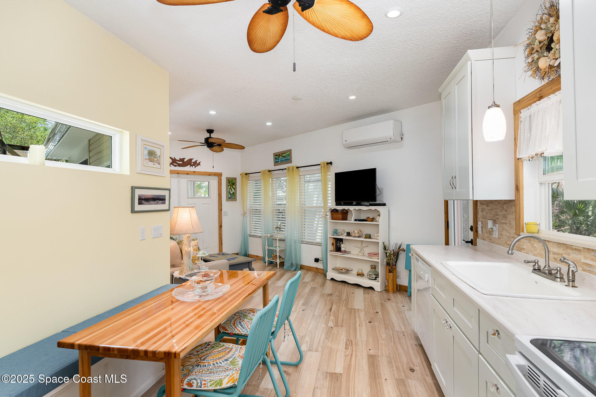 367 Oak Cove Road Titusville, FL 32780 - Photo 10 of 15 a room with stainless steel appliances kitchen island granite countertop furniture and a flat screen tv