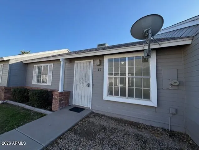 a backyard of a house with table and chairs