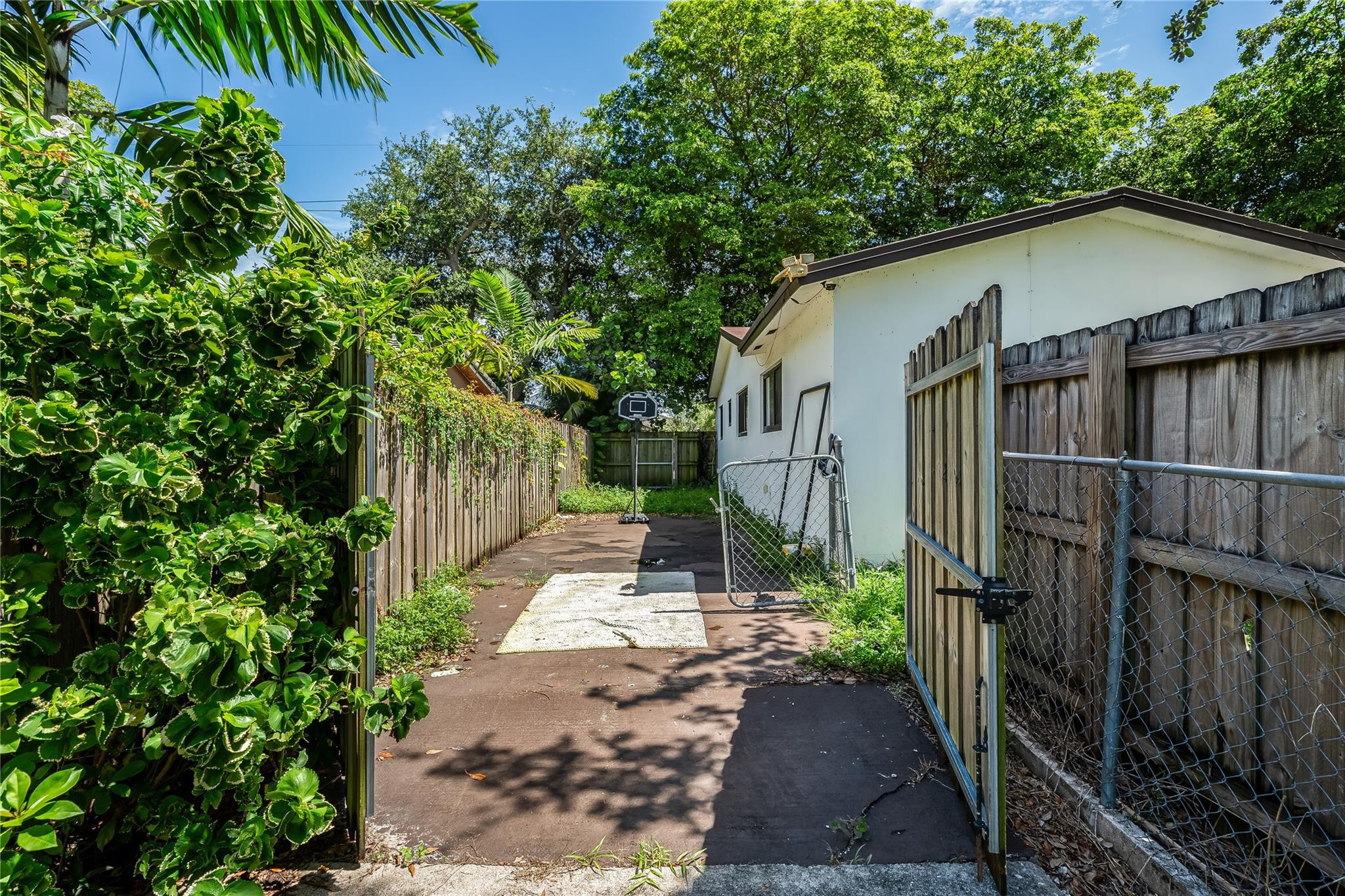3193 Taft Street Hollywood, FL 33021 - Photo 20 of 20 a view of a small yard in front of a house with wooden fence