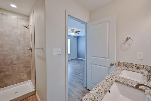 a bathroom with a tub and shower