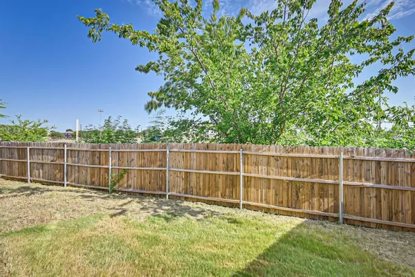 a view of a backyard with a small fence