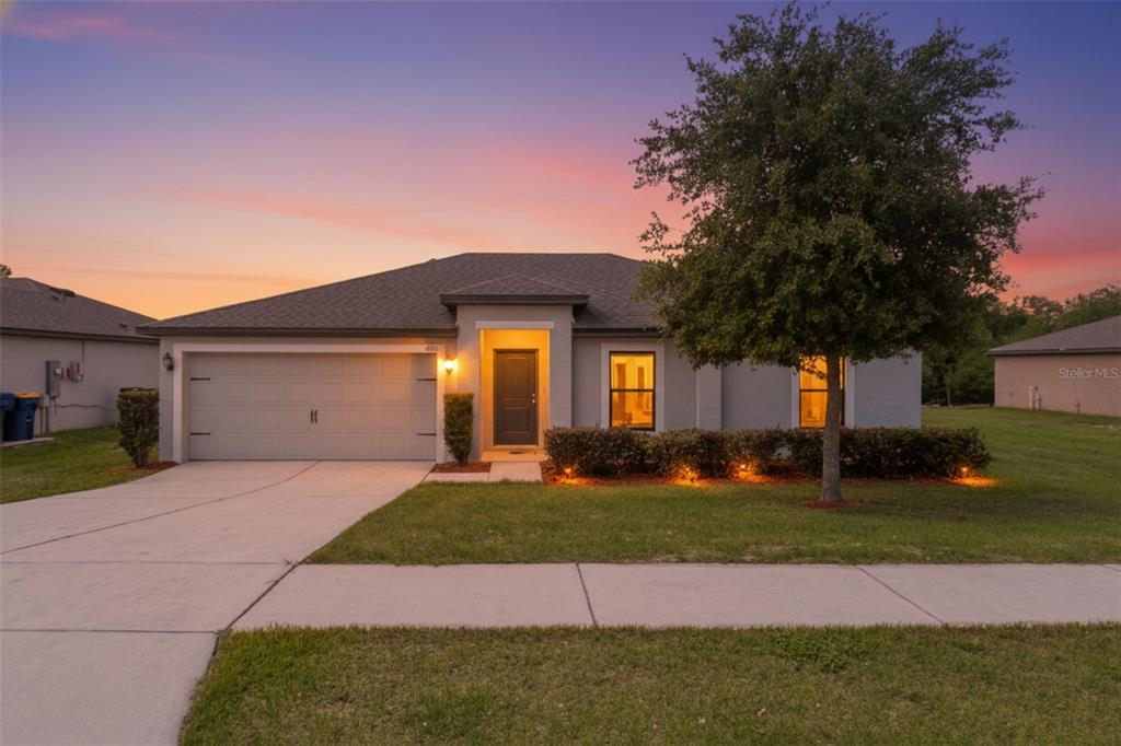 1613 Orne Street Mascotte, FL 34753 - Photo 1 of 31 a front view of a house with a yard