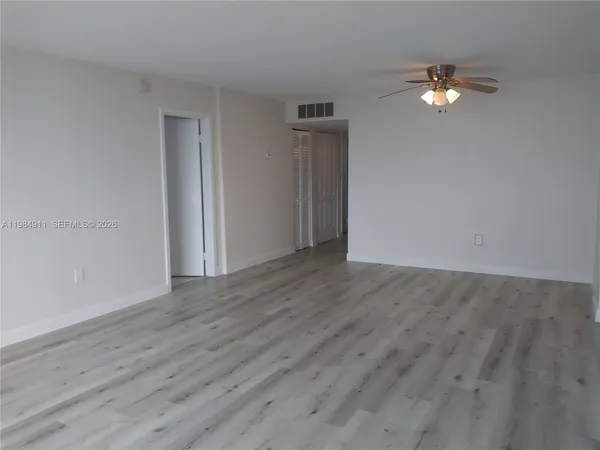 a view of a lake with boats and trees in the background