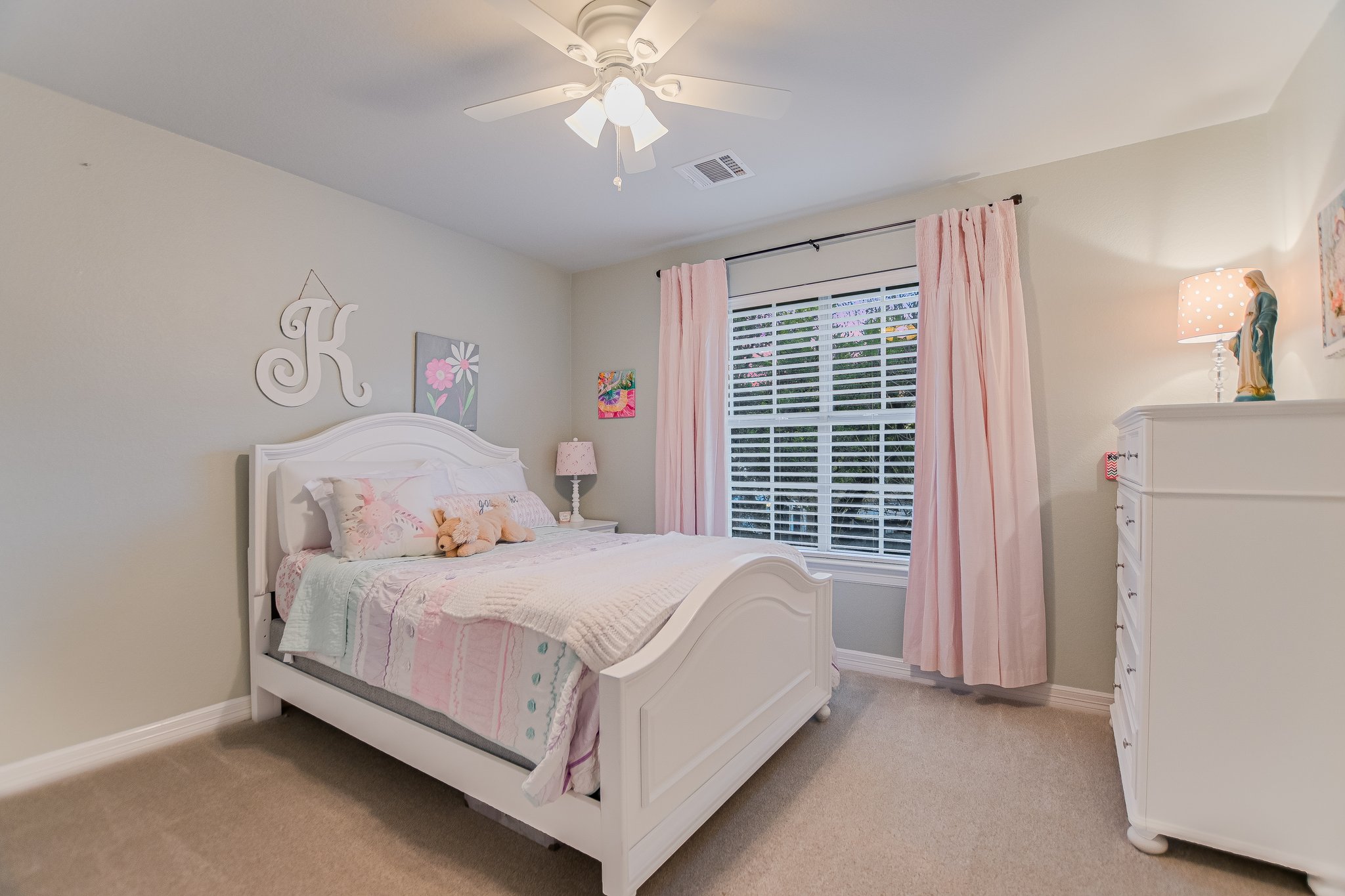 11100 Sheba Cove Austin, TX 78759 - Photo 11 of 29 a bedroom with a bed and a chandelier