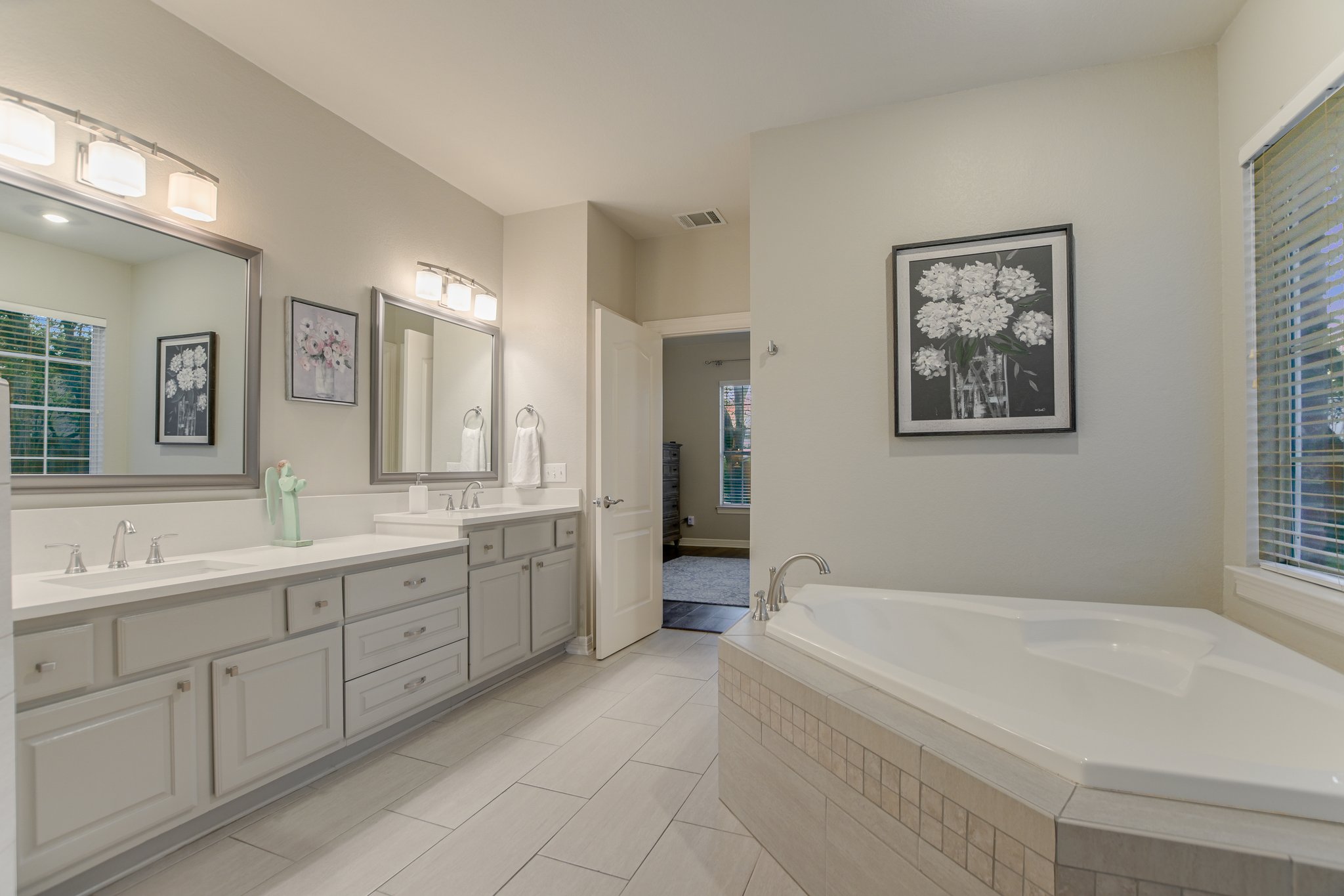 11100 Sheba Cove Austin, TX 78759 - Photo 21 of 29 a spacious bathroom with a granite countertop tub sink and mirror