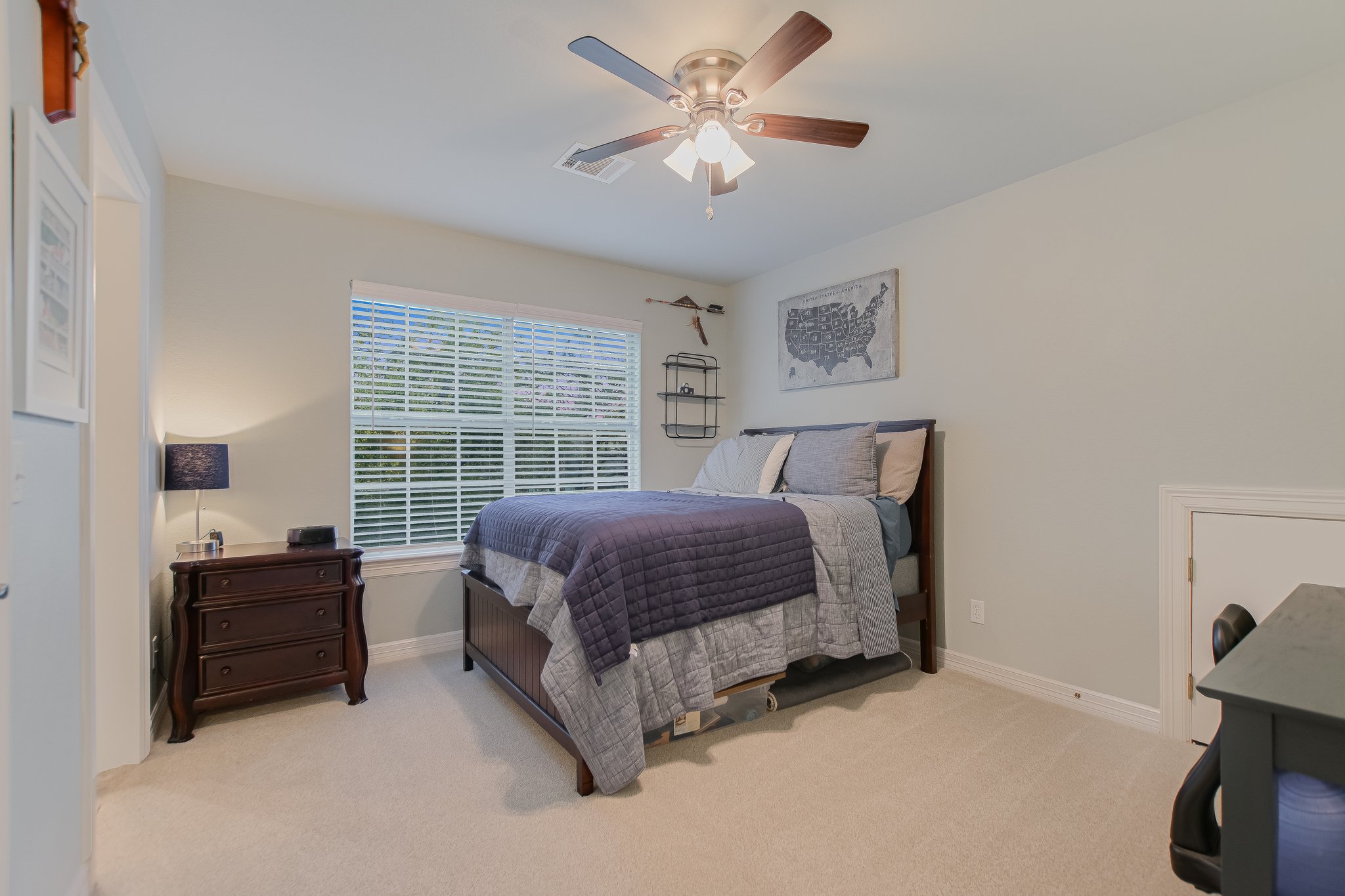 11100 Sheba Cove Austin, TX 78759 - Photo 26 of 29 a spacious bedroom with a bed and a chandelier