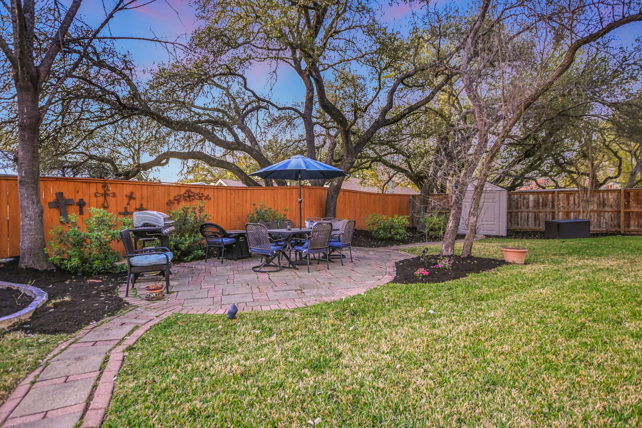 11100 Sheba Cove Austin, TX 78759 - Photo 10 of 29 a view of a backyard with table and chairs under an umbrella