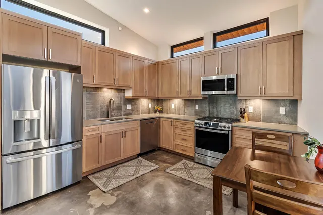 a kitchen with a refrigerator stove and sink