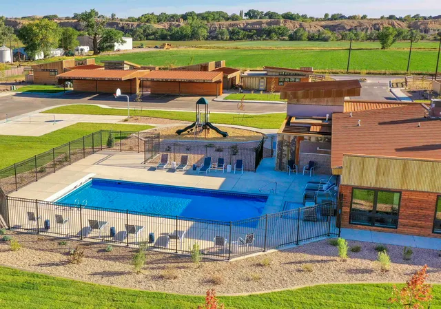 an aerial view of a house with a big yard
