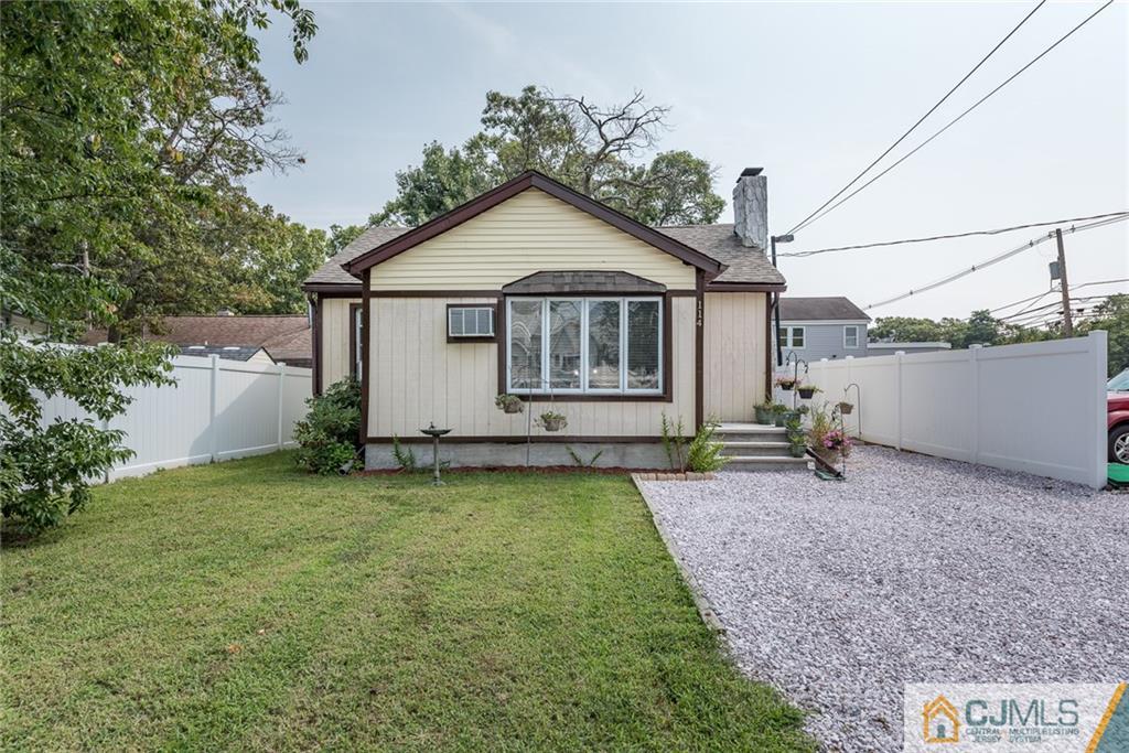 114 Dock Road Brick, NJ 08723 - Photo 1 of 25 a backyard of a house with table and chairs