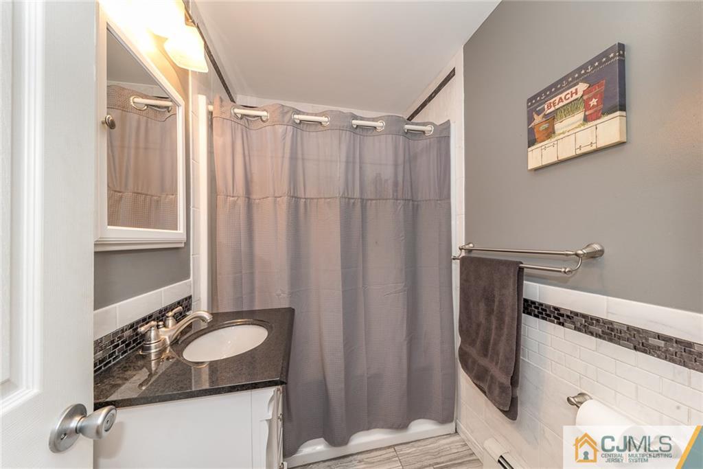 114 Dock Road Brick, NJ 08723 - Photo 14 of 25 a bathroom with a sink and a mirror