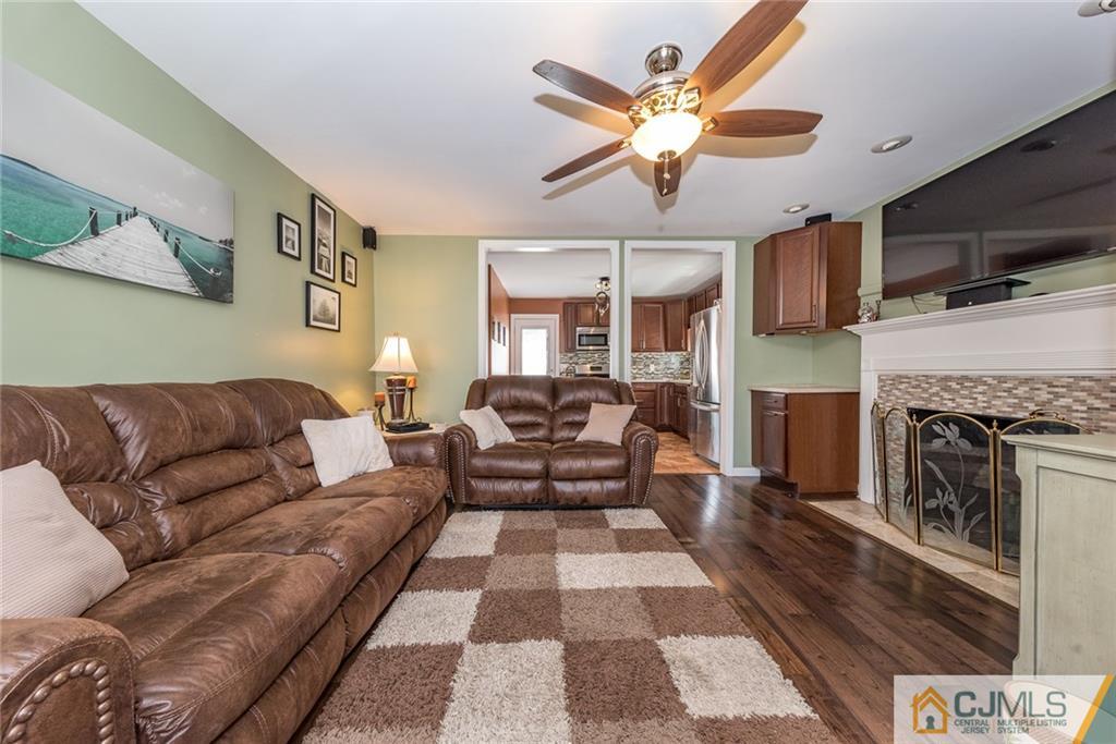114 Dock Road Brick, NJ 08723 - Photo 5 of 25 a living room with furniture and a fireplace