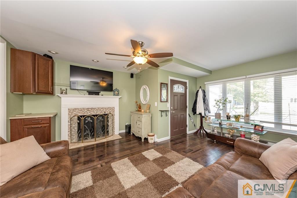 114 Dock Road Brick, NJ 08723 - Photo 7 of 25 a living room with furniture a flat screen tv and a fireplace