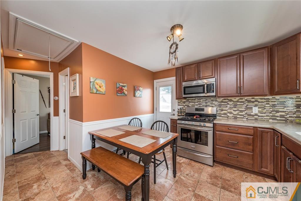114 Dock Road Brick, NJ 08723 - Photo 8 of 25 a kitchen with a stove a refrigerator and a sink