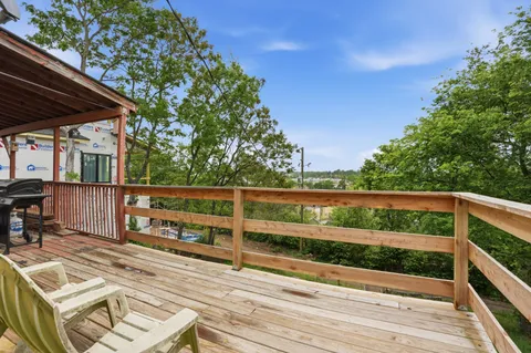 a view of balcony with wooden floor and outdoor seating