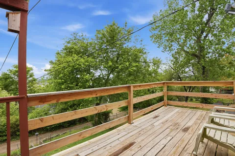 a view of balcony with wooden floor and fence