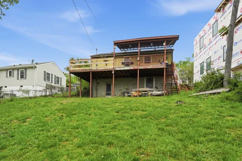 a view of an house with backyard porch and furniture