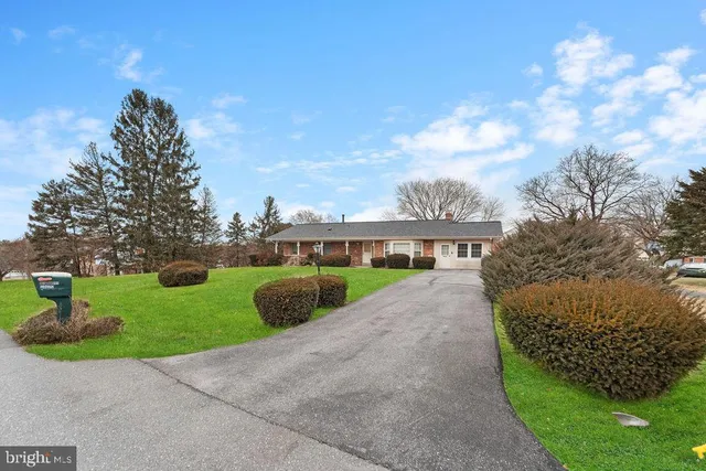 a view of a street with a houses in the background