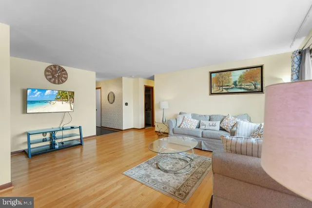 a dining room with furniture a chandelier and wooden floor