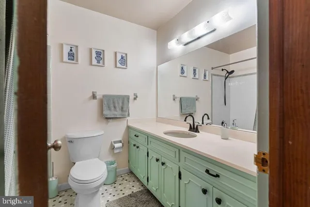 a white toilet sitting next to a bath tub