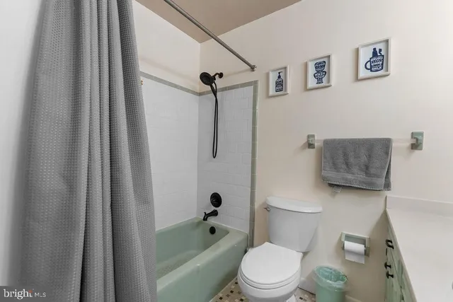 a spacious bedroom with a bed and a chandelier