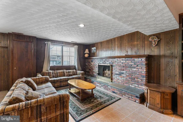 a living room with furniture a rug and a large window