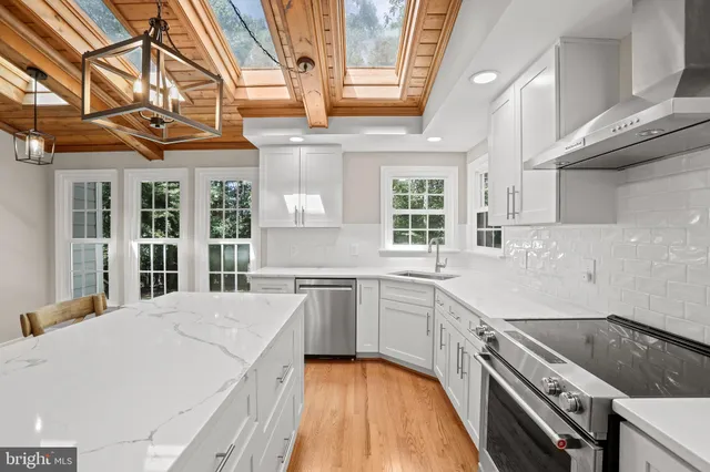 a kitchen with a sink stove and cabinets