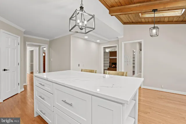 a room with a chandelier and a dresser