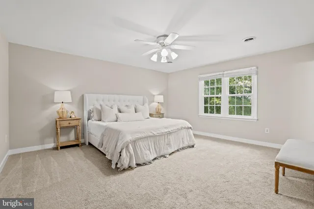 a spacious bedroom with a bed and a window